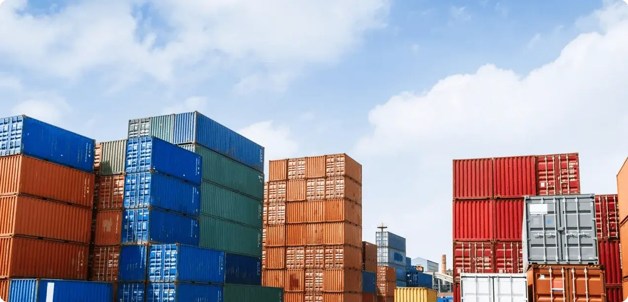 Stacks of multicolored shipping containers in a large outdoor storage yard