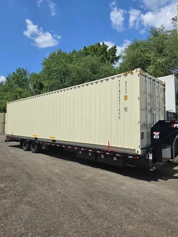 A 40ft high cube open-side shipping container with four doors on a tilt-bed truck, delivered to Taunton, MA.