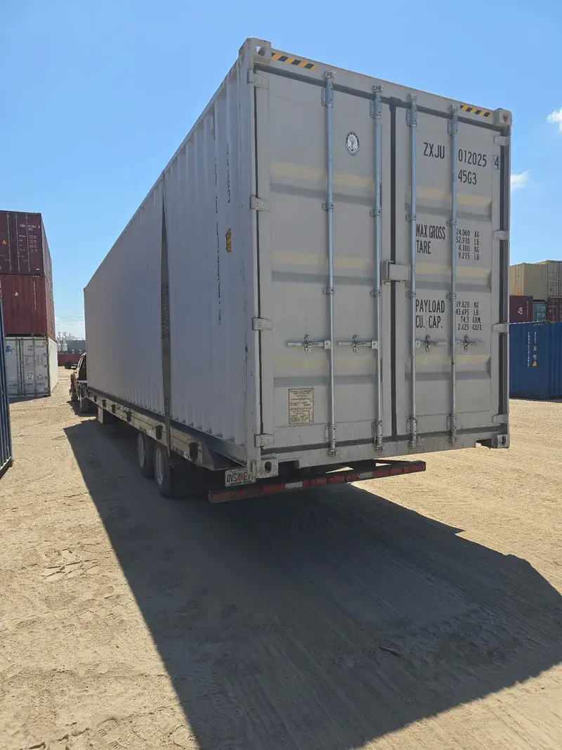 40'ft High Cube Open Side Container on a tilt-bed trailer